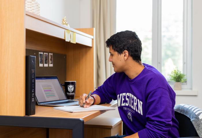 Student using computer in residence