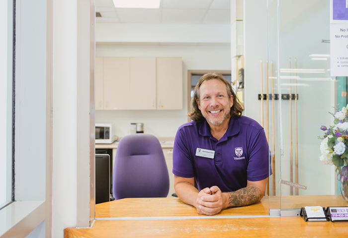 A front desk staff member looking into the camera